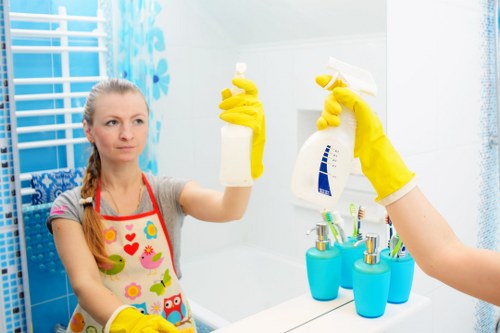 Cleaning professional wearing protective gloves while preparing an end of tenancy cleaning job