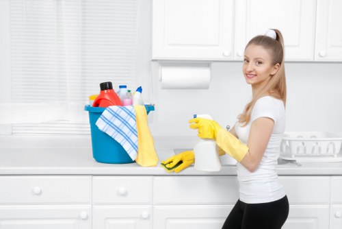 Technician cleaning fabric armchair upholstery in London